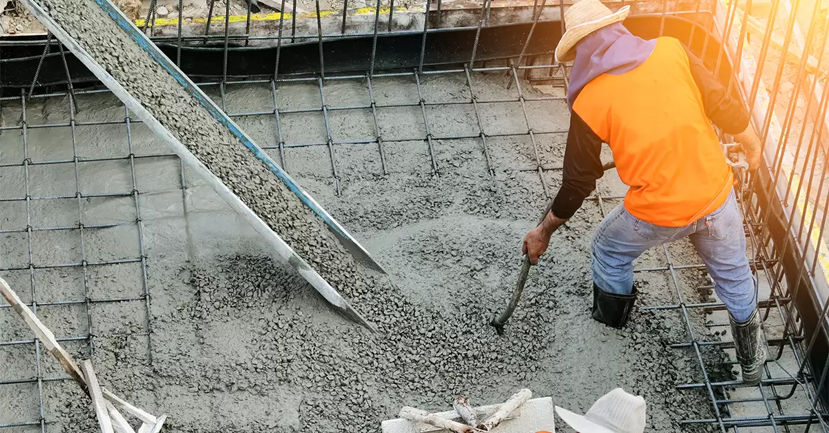 Concrete construction cost in Pakistan illustrated by concrete pouring and reinforcement work for road projects