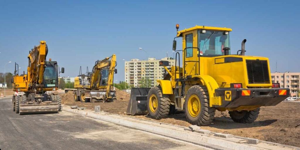 excavator and bulldozer performing excavation work at construction site