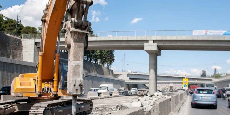 Road and highway construction project in Pakistan with heavy machinery and workers on site