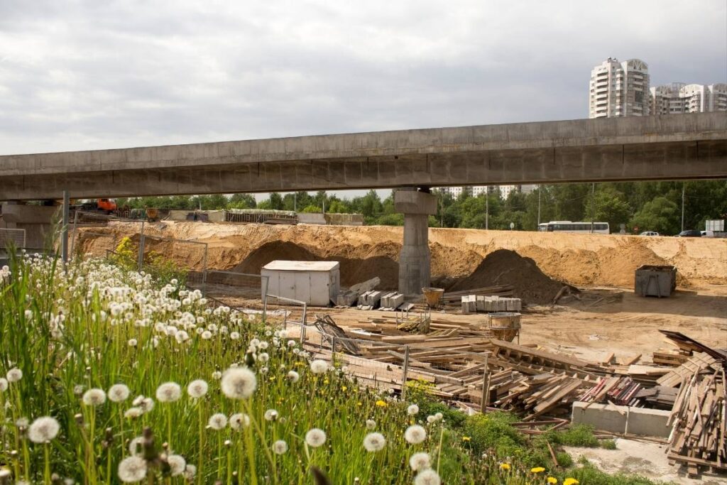A sweeping golden hour photograph of a major, recently completed concrete highway and multi-level flyover bridge network in Pakistan, showcasing stable, high-quality engineering and robust foundations.